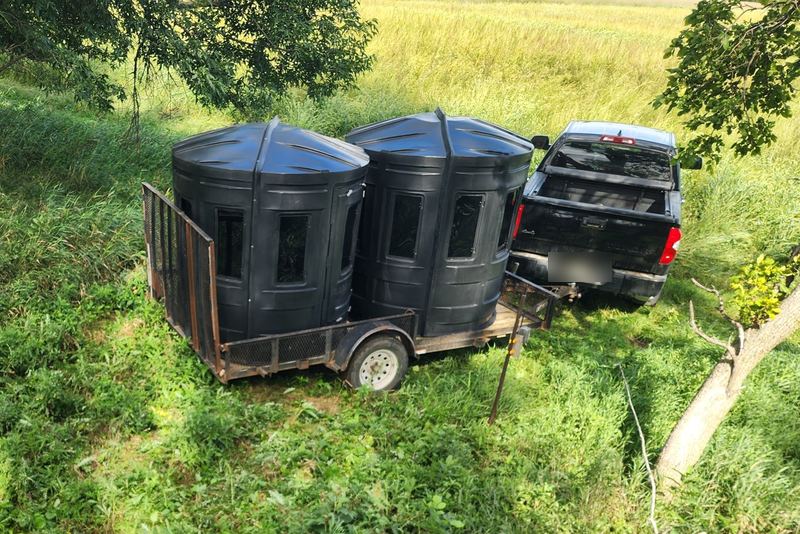 Two enclosed deer blinds on a trailer being set out on a Double P Ranch bow property